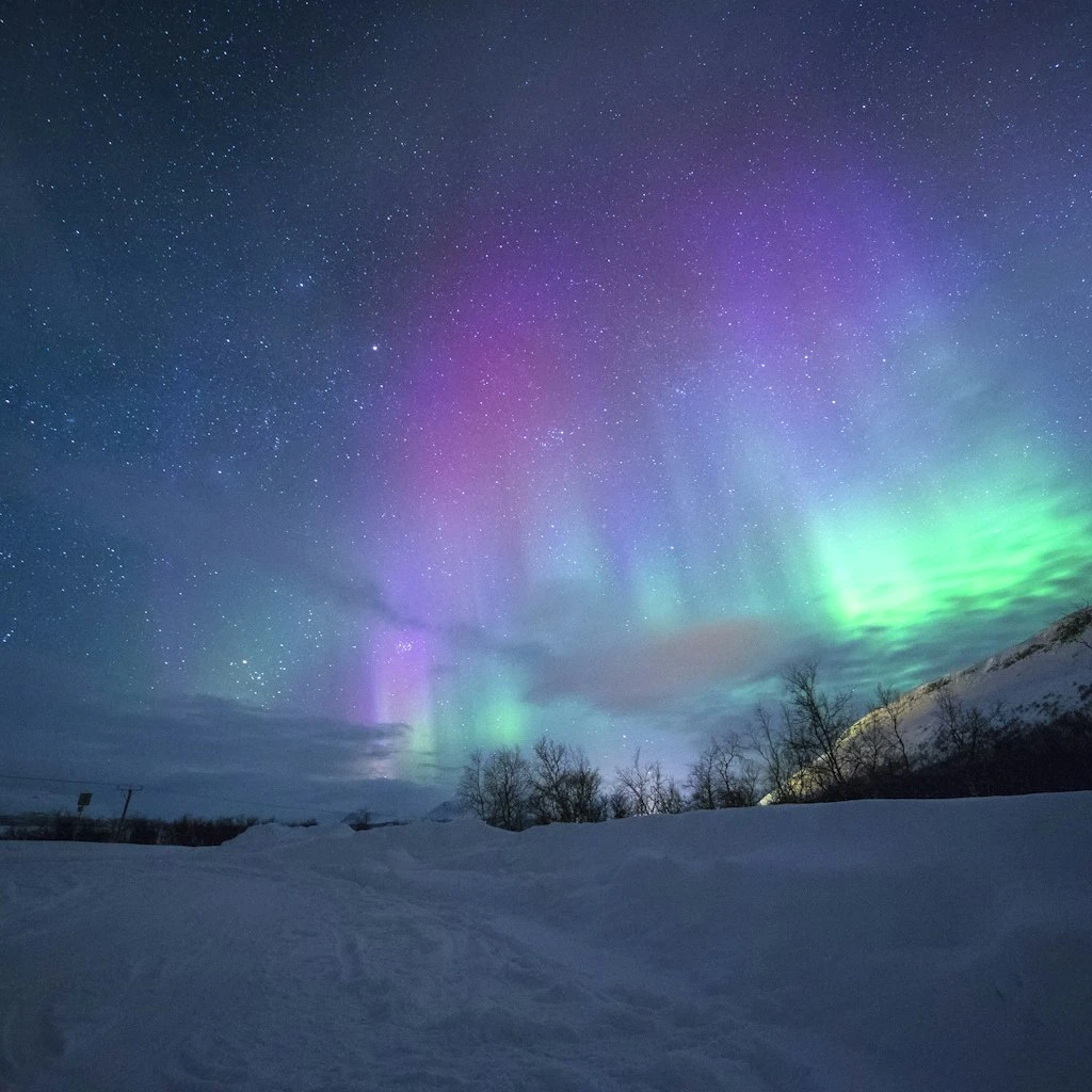 Northern Lights Aurora Borealis Over Snow Peaks